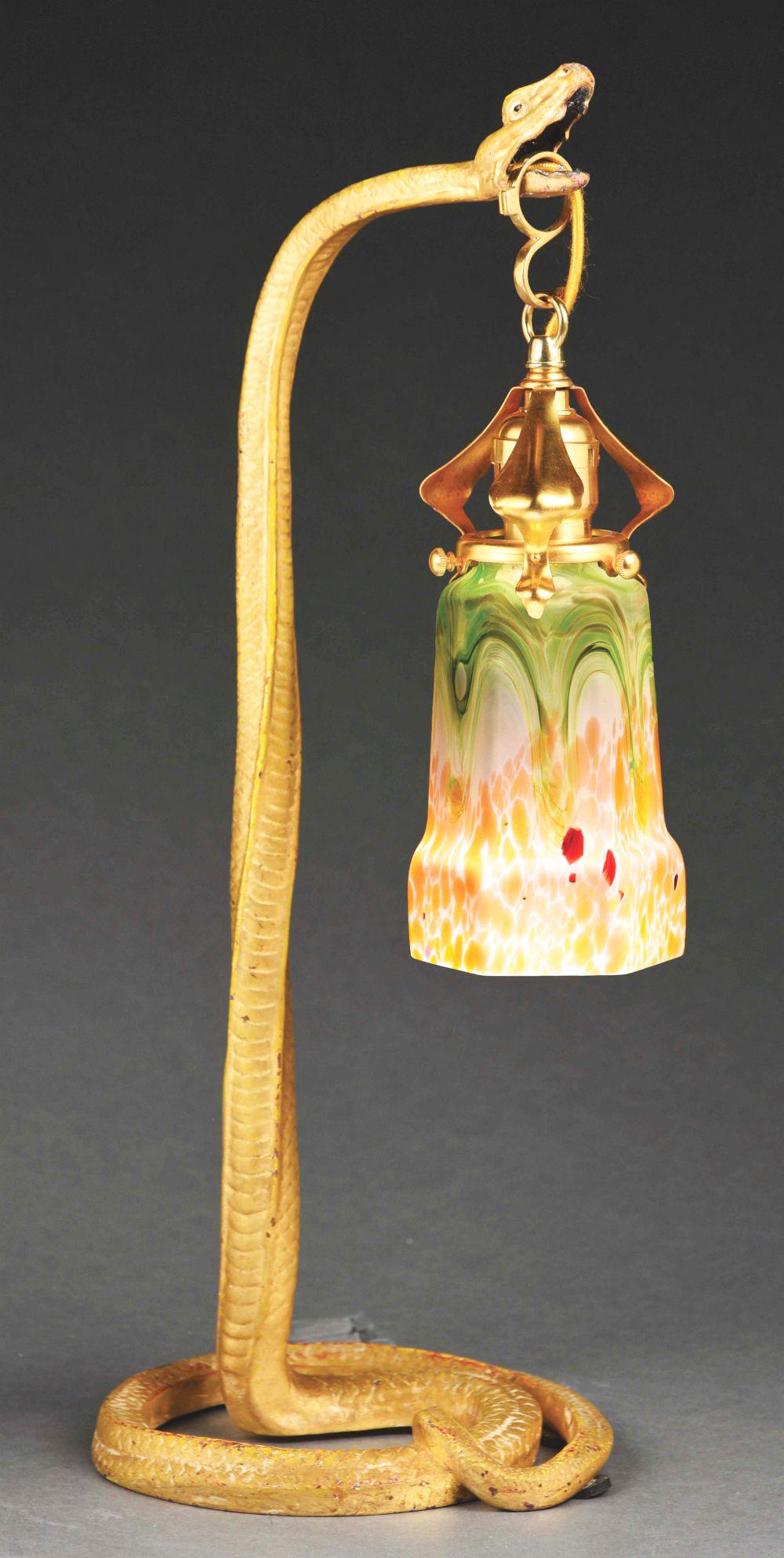 LOETZ SNAKE LAMP.: A beautiful table lamp by Loetz. The six sided glass shade stands 6" tall. It features green, white, orange and red glass with the bottom half of the shade featuring an oil spot pattern. Condition: Ex