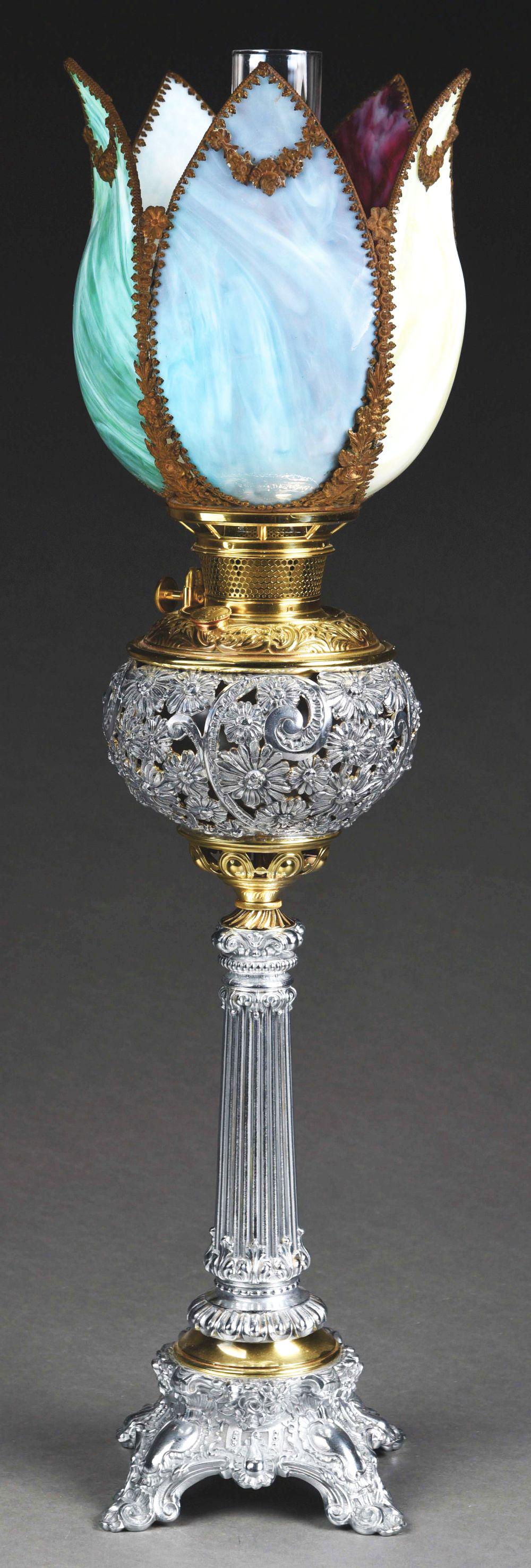 BRADLEY & HUBBARD BANAQUET-STYLE OIL LAMP.: A beautiful Bradley & Hubbard banquet lamp. The 31 - 1/2" tall lamp has a tulip form slag glass shade with panels in green, purple, yellow, red and white. The shade sits on a silver and brass oil lamp