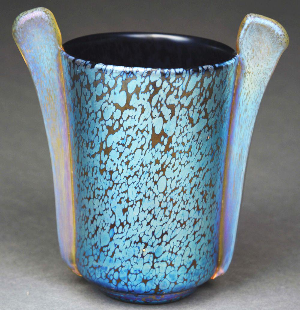 LOETZ BLUE VASE.: A gorgeous blue vase by Loetz. The 6 - 1/2" tall vase features a blue oil spot pattern with lovely iridescence. The vase has two applied glass decorative components adorning the sides of the vase. Con