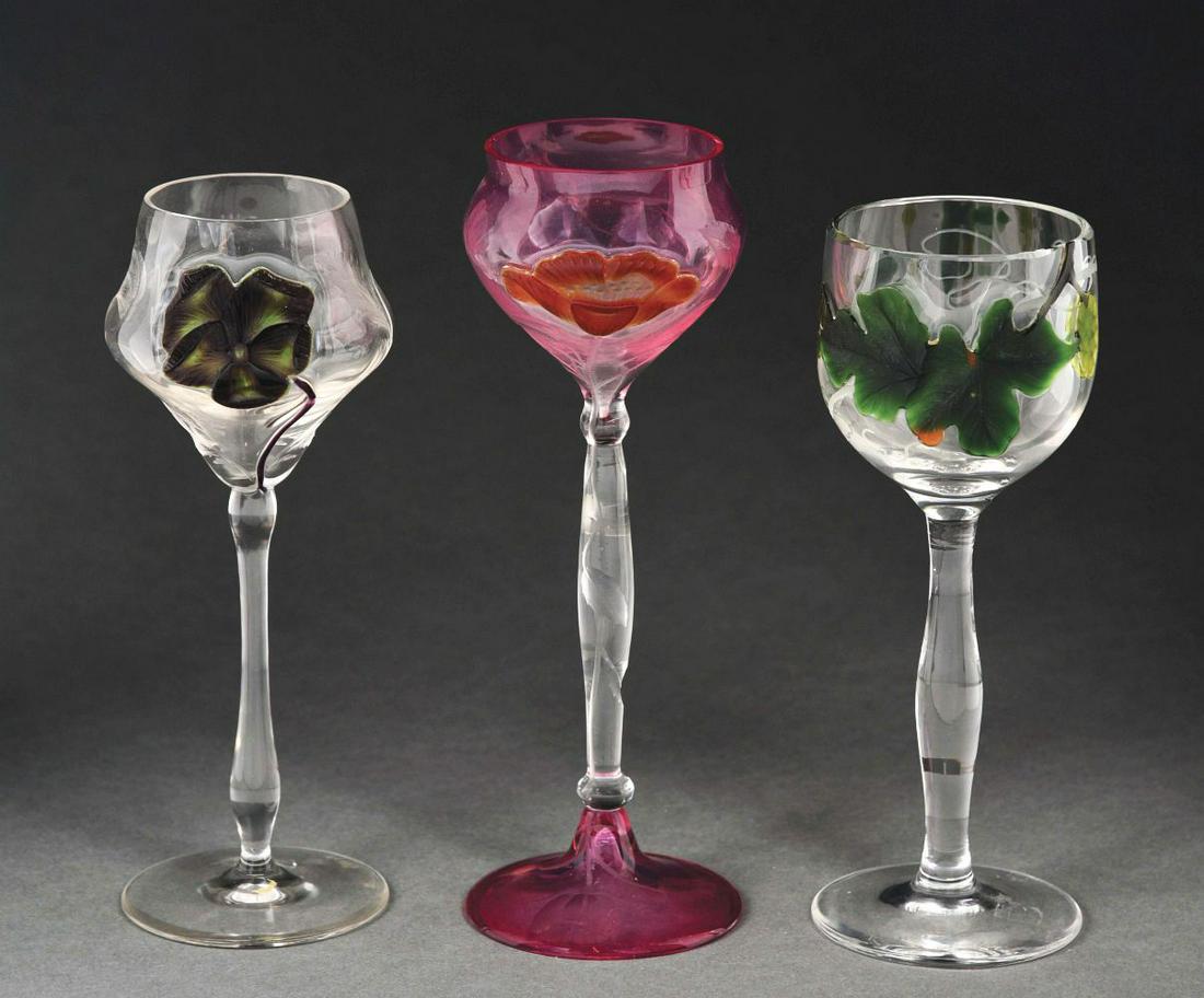 LOT OF 3: MOSER WINE GOBLETS.: (A) This is an 8 - 1/2” marquetry wine with a beautiful poppy flower and cut flower base. (B) This 7 - 3/4” stemmed wine has an elevated green leaf design and a clear crystal stem. (C) Thi