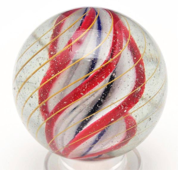 Large Ridge Core Swirl Marble.: Description White base with cobalt in the valleys and red on ridge edges. Outer bands are birdcage yellow latticino. Polished with minor surface chips. Photo list: B, C, and D. Condition (Polished). S