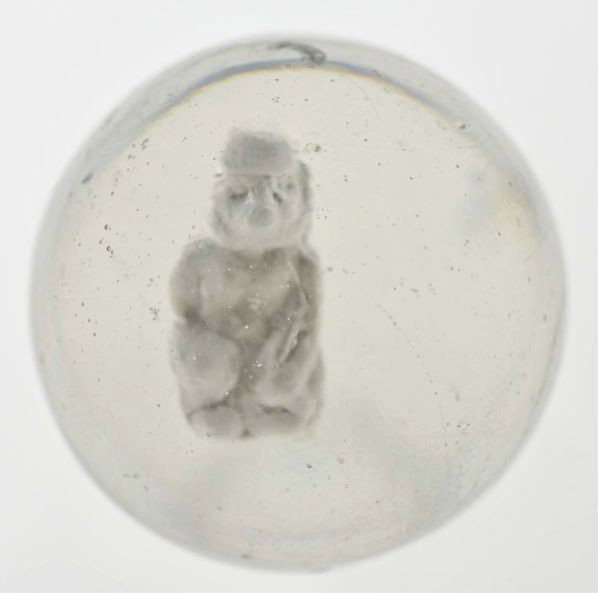 Seated Monkey Sulphide Marble.: Description Monkey wearing fez figure with good detail. Slight reflection on top of marble. Photo list: B, C, and D. Condition (9.3). Size 2"" Dia."
