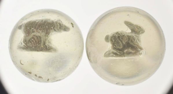 Lot of 2: Sulphide Marbles.: Description The smaller marble is a bear standing figure that is centered high and to the right with great detail. Photo list: B, C, and D. The larger marble is a rabbit hopping figure that is well-ce