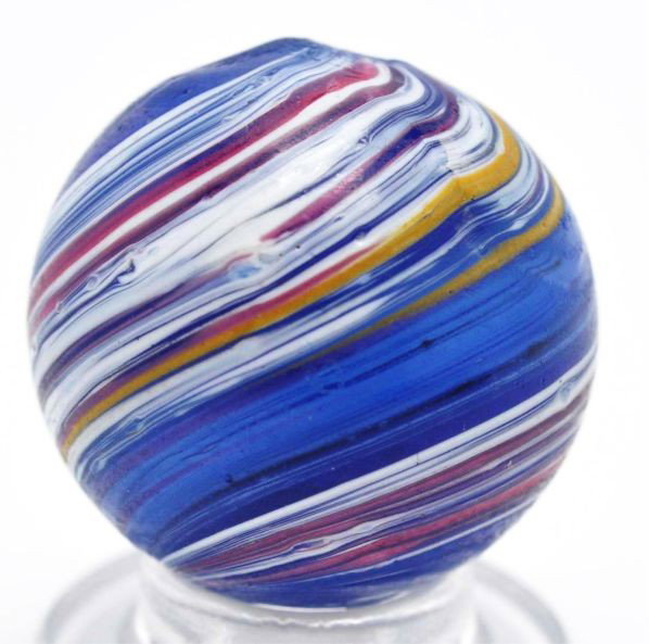 Submarine Indian Marble.: Description Transparent blue base glass with nice submarine underlaid in white bands. Outer panels are opposing pink and white and pink, white, and yellow. One minor flea bite. Photo list: B, C, and D