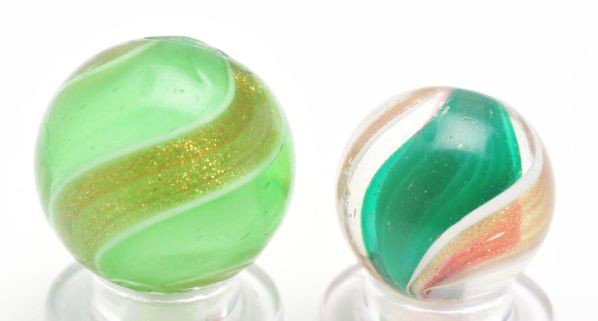 Lot of 2: Ribbon Lutz Marbles.: Description The smaller marble has a red and green ribbon with wide lutz banding and the larger marble has a white ribbon with light green base glass. Condition (8.7). Size 21/32"" and 25/32"" Dia."