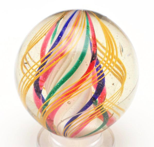 Large 3-Stage Solid Core Swirl Marble.: Description White solid core with second stage of alternating blue, red, and green bands. Outer decoration in groups of yellow latticino. This marble is polished with minor chips still showing near po