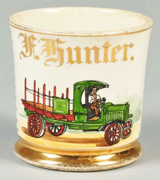 Open Stake Truck Semi Vitreous Shaving Mug.: Description Gilt name "F. Hunter". K.T. & K mark on bottom. Full light blue wrap. One tight hairline inside and one on bottom base with overall crazing and minor staining. Minor to moderate gold loss