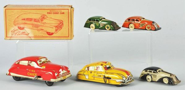 Lot of 5: Tin Marx & Courtland Auto Wind-Up Toys.: Description American. Includes Courtland Fire Chief Car with original box, one Marx Yellow Cab, and three Marx Tricky Taxies in different colors. Various condition.Condition (Very Good). Size Largest: