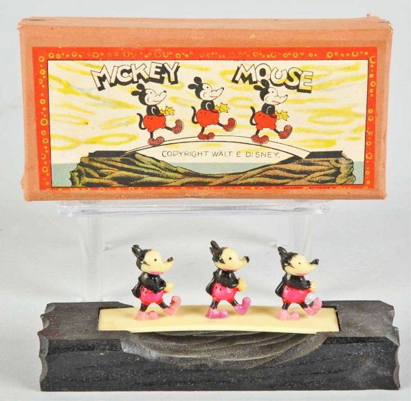 Walt Disney Mickey Mouse Bridge Walking Toy.: Description Japanese. Pre-war. Wooden base and celluloid figures. Depicts three Mickey figures walking across a bridge. Includes scarce original box with beautiful paper label.Condition (Near Mint). S