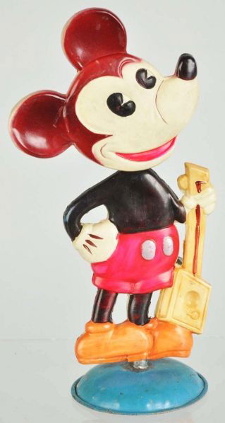 Celluloid Mickey Mouse Nodding Toy.: Description Japanese. Pre-war. Tin base and celluloid figure. Mickey is holding a guitar. Original inspection sticker and Mickey Mouse figure on back of figure. Black on Mickey's head is faded to brow