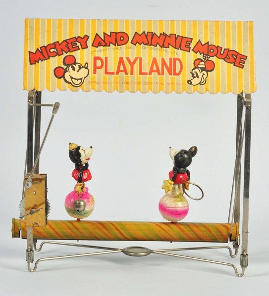 Walt Disney Mickey Mouse Play Land Toy.: Description Japanese. Tin frame with celluloid Mickey and Minnie figures rotating back and forth on celluloid balls. Original bell and hoop. "Walt Disney Enterprise" label on Minnie's ball. Minnie's f