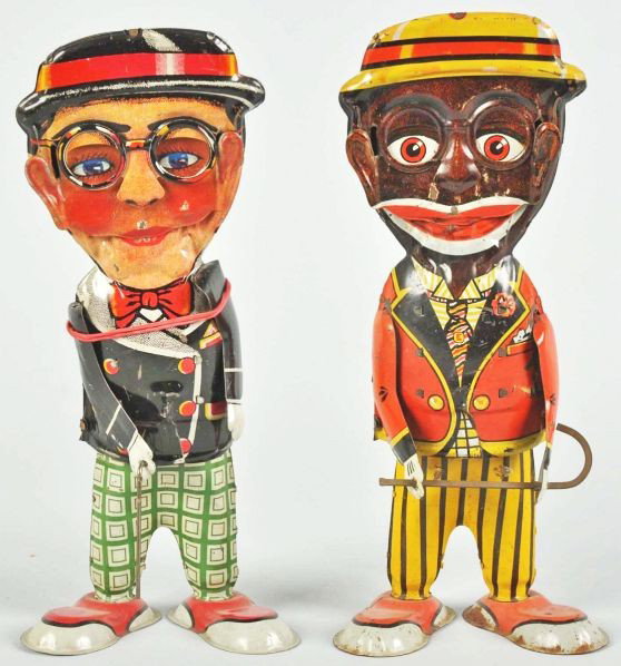 Lot of 2: Tin Litho Marx Walker Wind-Up Toys.: Description American. Working. Includes one depicting Harold Lloyd and one Mammy. All original arms and canes. Some scratching and wear throughout and the Mammy toy with corrosion on feet.Condition (V