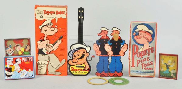 Lot of 5: Popeye Toy Items.: Description Includes Mattel Popeye Getar in original box, Popeye Pipe Toss in original box, one small paint set, and two dexterity puzzles.Condition (Very Good). Size Largest: 14" L.