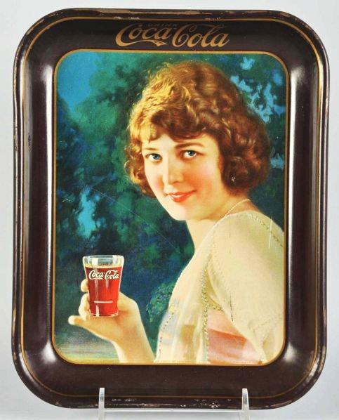 1924 Coca-Cola Brown Rim Serving Tray.: Description A few surface scratches and one or two small dark marks to face; otherwise, clean and colorful. Also, some outer edge nicks and chips.Condition (Very Good Plus). Size 13 - 1/4" x 10 - 1/2"