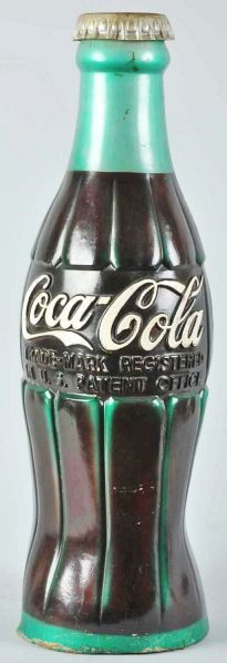 Hard Rubber Coca-Cola Large Display Bottle.: Description 1950s. Still retains good color and appearance with the original cap. A few chips, splits, general soiling, slight warping, and rubber loss to base.Condition (Very Good). Size 41" T.