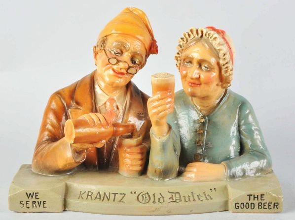 Krantz Old Dutch Beer Figural Advertising Piece.: Description Composition. Nice figure of man and woman, both drinking a glass of Krantz Old Dutch Beer.Condition (Excellent Plus). Size 12 - 1/2" x 18".