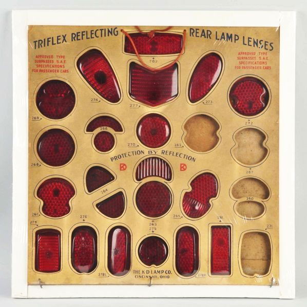 Triflex Rear Lamp Reflectors Store Display.: Description 1930s to 1940s. Heavy cardboard construction with old rope hanger. Still complete with the exception of all but four taillight lenses. General overall edge wear, soiling, light marks, and