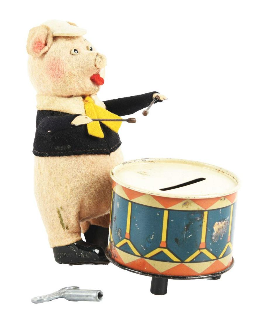 PIG PLAYING DRUM WIND-UP BANK. (1 of 7)