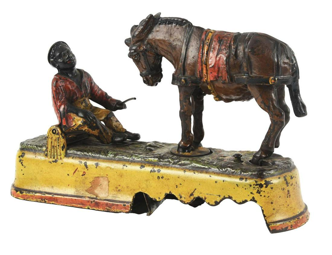 'SPISE A MULE MECHANICAL BANK YELLOW BASE.: Made by J & E Stevens. Post under the mules front legs has been repaired.Condition:(Good - Very Good).Dimensions:9 - 1/2" x 2 - 1/2" x 6 - 1/2".