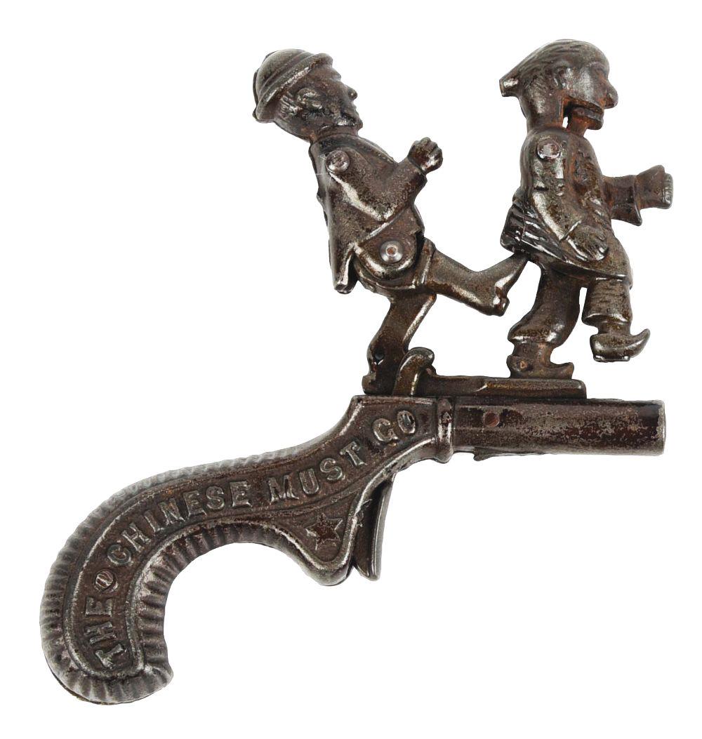 IVES "THE CHINESE MUST GO" CAP PISTOL.: C. 1879. Probably the hardest to find of the rare cast iron Mechanical Cap Guns. When trigger is pulled, the man holding the Chinaman’s queue or braid, kicks the Chinaman's butt exploding the ca