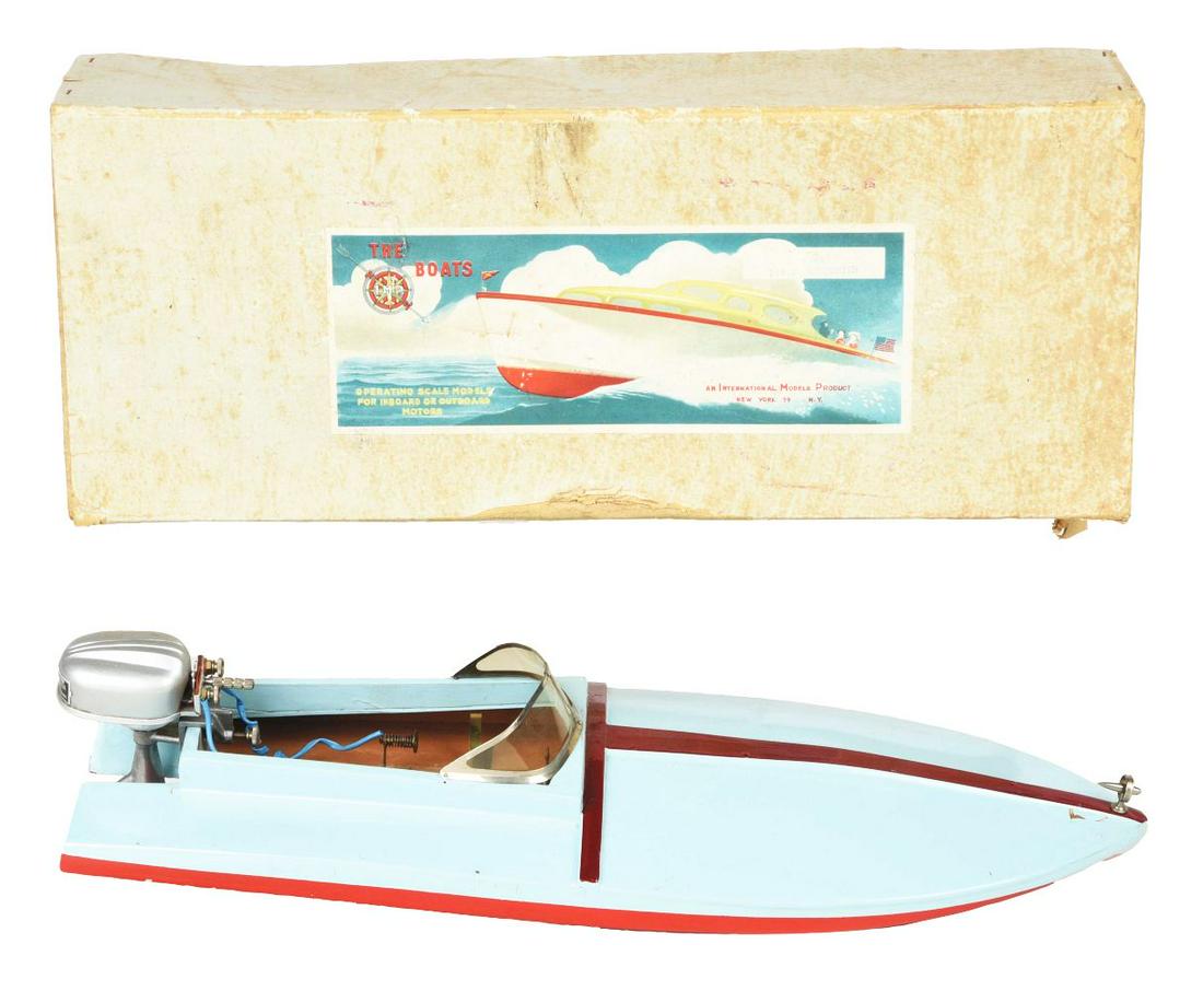 JAPANESE BATTERY-OPERATED WOODEN SPEEDSTER BOAT.: Original box marked "I.M.P 5485 Speedster." Nice paper label on box. Toy is unusual model with beautiful styling. Appears to have instruction sheet inside. Blue with maroon trim. Original front emblem