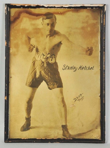 Framed Stanley Ketchel Boxing Picture.: Description Marked "Danna Photo" and shows Ketchel wearing his middleweight Championship Belt. Heavy water staining to upper portion of picture. Needs to be re-framed.Condition (Good). Size Framed: 29