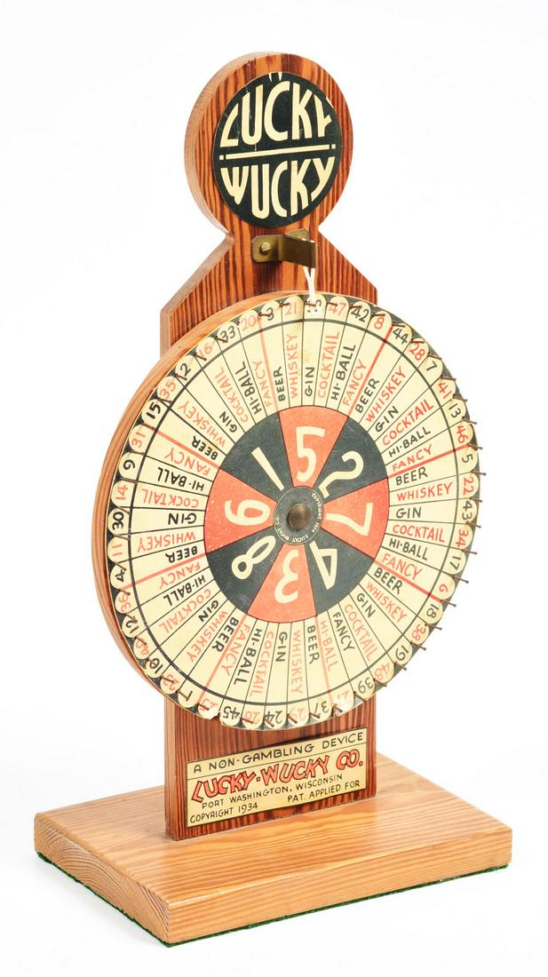 LUCKY-WUCKY CO DRINK WHEEL.: A great bar amusement called the "Lucky Wucky" drink wheel. Spin the dial and get your drink. Also has roulette numbers on the wheel for an added attraction. Condition:(Very Good).9" x 5 - 5/8" x 17".