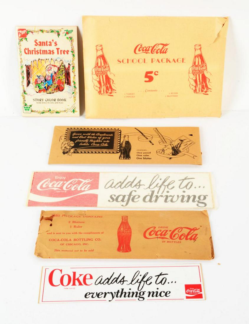 COCA-COLA MEMORABILIA.: Consists of a Coca-Cola coloring book, Coca-Cola school package, several other Coca-Cola teacher's aides and a couple of bumper stickers.Condition:(8.0 - 9.0).Largest: 12" x 9".Dimensions:
