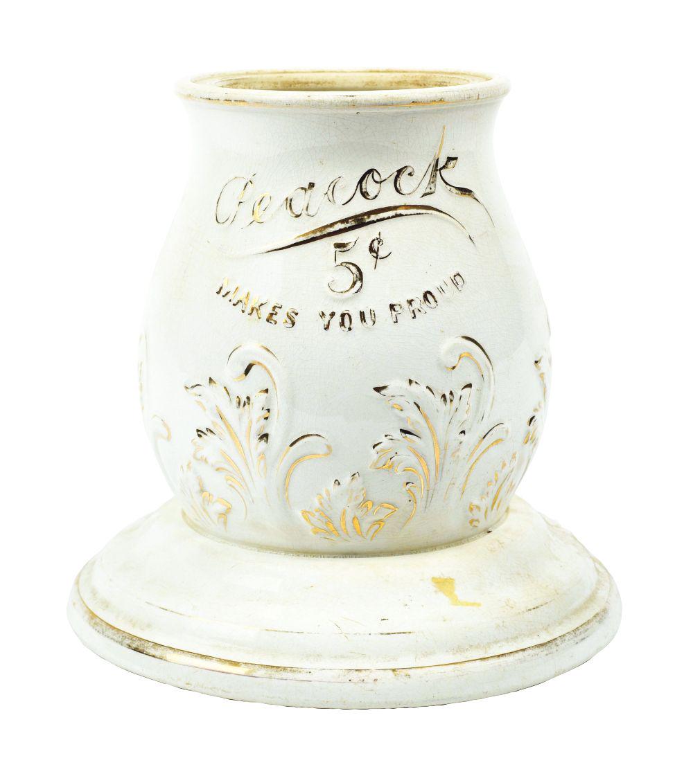 CERAMIC BASE FOR A 5Â¢ PEACOCK SYRUP DISPENSER. (1 of 4)