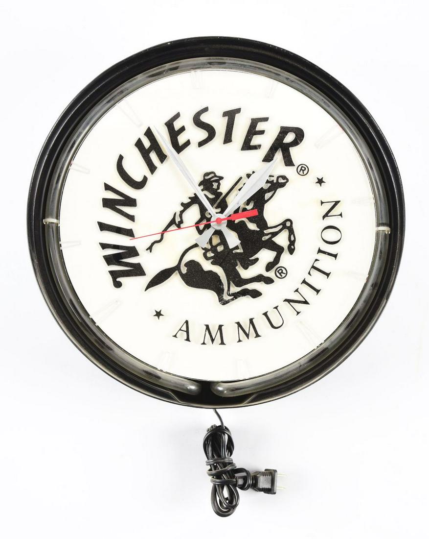 WINCHESTER AMMUNITIONS LIGHT-UP CLOCK.: Contemporary neon clock advertising Winchester Ammunition. Complete and needing a transformer. Condition:(Good).14 - 1/2" x 14 - 1/2" x 3 - 1/4".Dimensions: This is not a standard shippable item and w