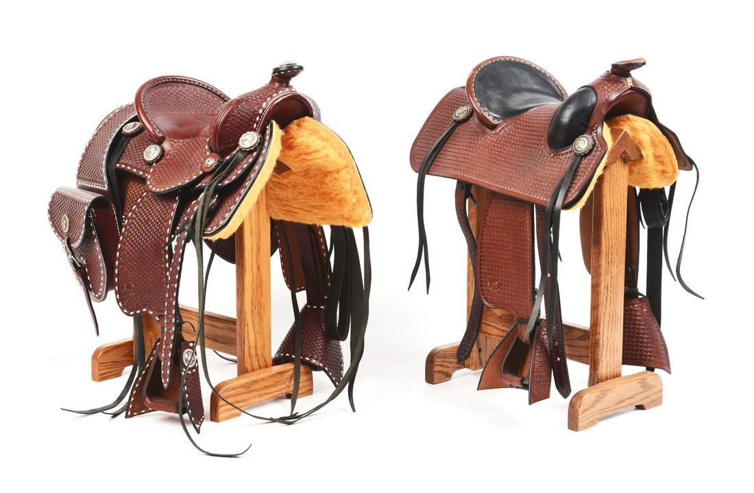 LOT OF 2: HOMEMADE MINIATURE LEATHER SADDLES ON WOODEN STANDS. (1 of 2)