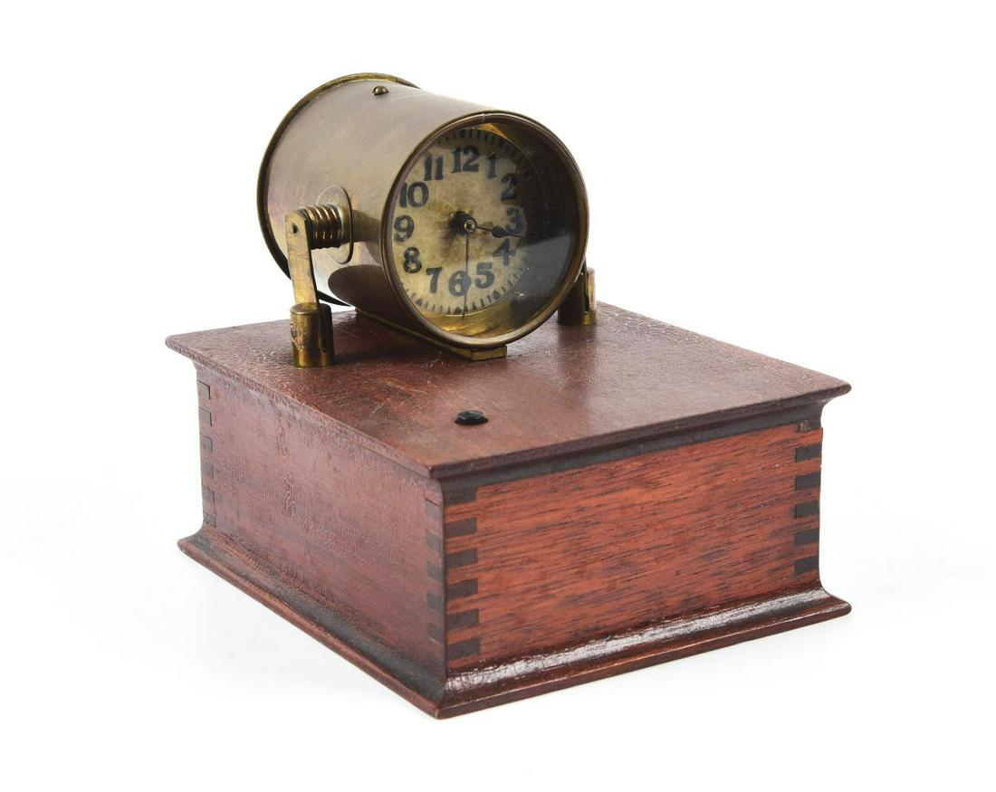 BRASS CLOCK MOUNTED ON WOODEN BOX. (1 of 2)