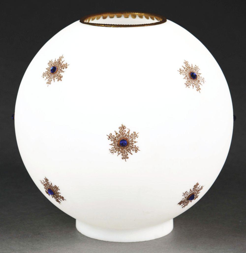 WHITE LAMP GLOBE WITH SNOWFLAKES AND BLUE JEWELS.: 9" diameter globe shade comprised of frosted white glass, applied snowflake design with small studded blue glass jewels. Some light surface scuffs, otherwise very good condition.Condition:(Very good).