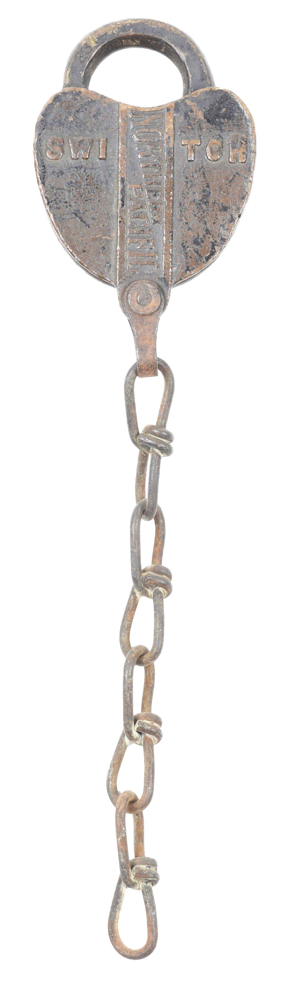 RAILROAD LOCK.: A brass switch lock made for the Northern Pacific Railway, nicely embossed "Northern Pacific" in bowtie arrangement in panel, with "Switch" embossed perpendicularly. Dust cover has "Adlake" embossed.