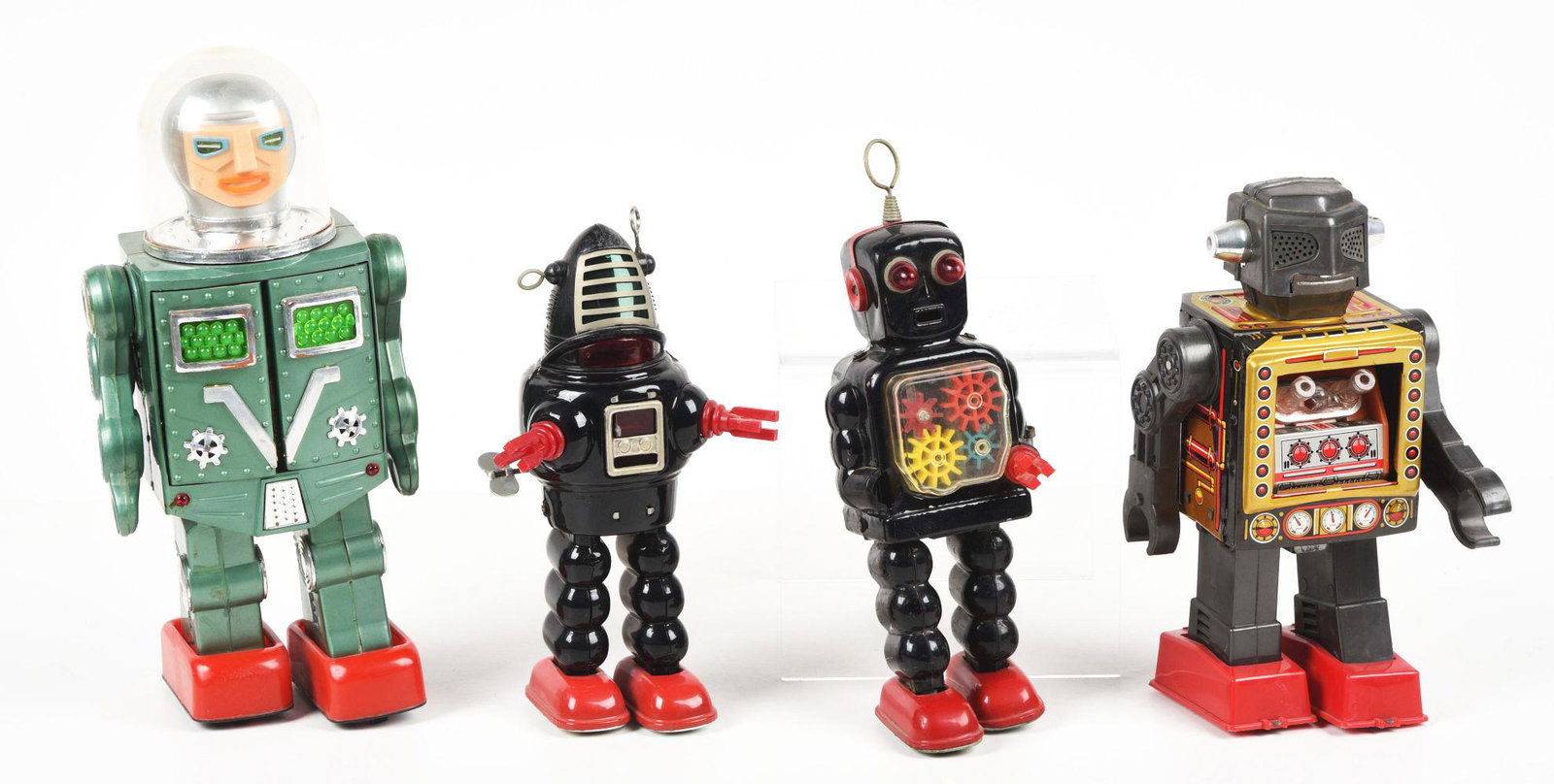 LOT OF 4: VARIOUS JAPANESE & HONG KONG WIND-UP & BATTERY-OPERATED ROBOTS.: One fires gun from chest, one is a small gear robot missing hand, one is a planet robot with plastic hands, and the last one is a battery-operated lunar robot from Hong Kong. Various conditions.Condit