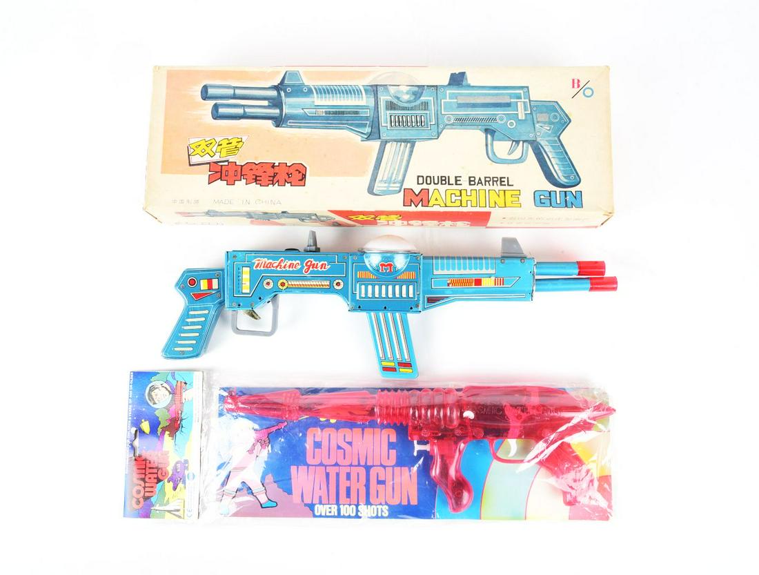 LOT OF 2: TIN LITHO & PLASTIC CHINESE MADE TOY MACHINE GUNS.: One in original box marked "Double Marrel Machine Gun" with double inserts. The other one is marked "Cosmic Water Gun."Condition:(Very Good - Excellent).Largest Box: 20" x 6 - 1/2" x 3".Dimensions: