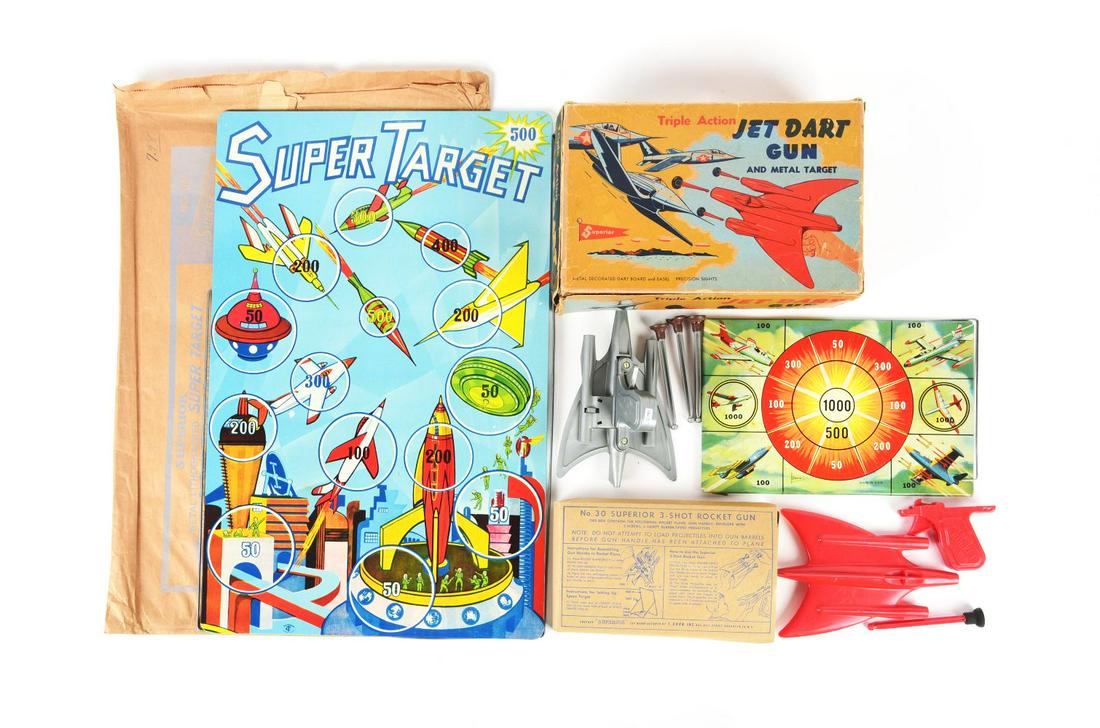 LOT OF 3: SUPERIOR-MADE PLASTIC GUNS SETS & TIN LITHO TARGET BOARD.: Jet Dart Gun in original box with darts and target, Three-Shot Plastic Rocket Gun in original box and a large metal target in envelope.Condition:(Very Good - Excellent).Largest Box: 23 - 1/2" x 16 - 1