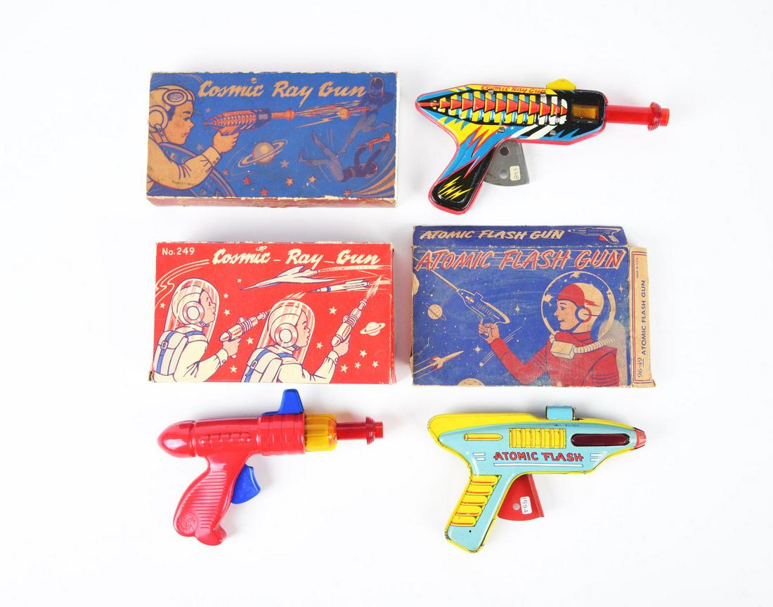 LOT OF 3: AMERICAN-MADE TIN LITHO & PLASTIC SPACE GUNS IN ORIGINAL BOXES.: Two of the boxes are missing end flaps. All friction powered. Two are tin litho and one is plastic. Two Cosmic Ray Guns and an Atomic Flash Gun.Condition:(Very Good).Largest Box: 8" x 4 - 3/4" x 1 - 3