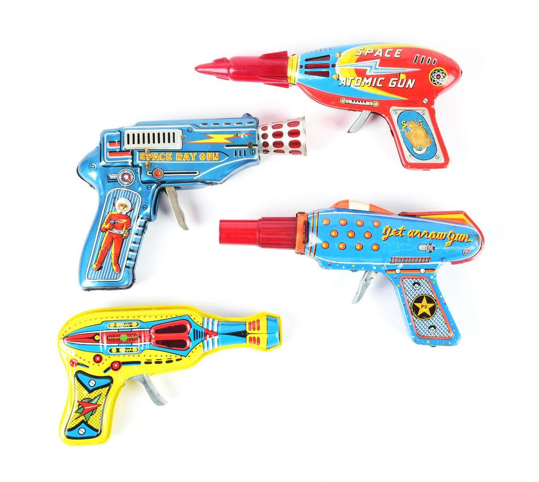 LOT OF 4: TIN LITHO & PLASTIC JAPANESE-MADE FRICTION RAY GUNS.: There's an Atomic Gun, Space Ray Gun, Jet Arrow Gun and another. Some scratching.Condition:(Very Good).Largest: 7 - 1/4" x 5 - 1/2" x 1 - 1/4".Dimensions: