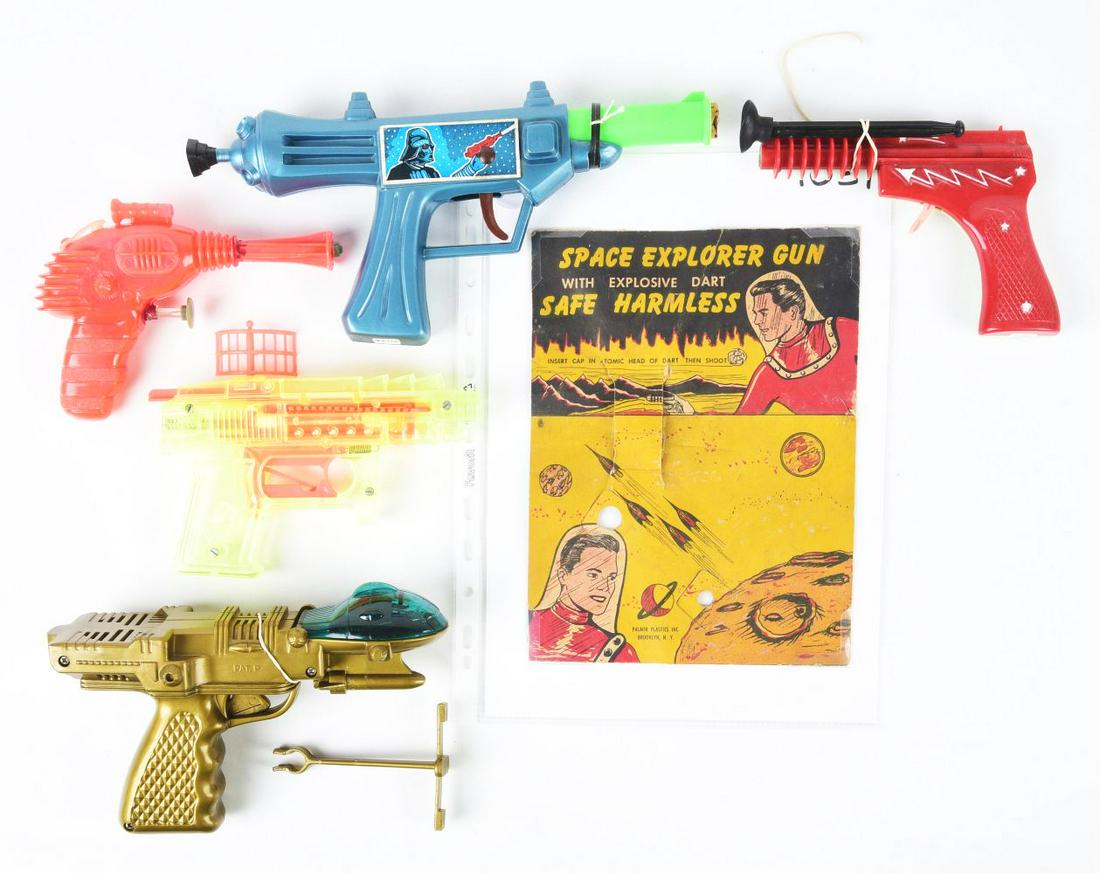 LOT OF 5: VARIOUS PLASTIC SPACE GUNS.: One is made by Palmer Plastics, and has original colorful header card and dart. One has Darth Vader character decal. One has moveable radar signal on top. One is marked "1986," battery-operated with a
