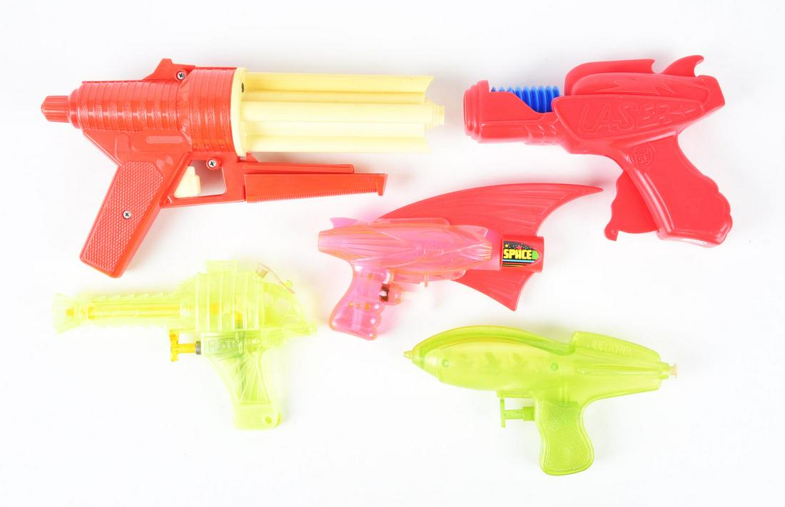 LOT OF 5: VARIOUS SPANISH & ITALIAN-MADE PLASTIC SPACE GUNS.: Four are squirt guns, and one is a four barrel rocket firing gun that does not include rockets. One of the plastic guns is marked "Uraina" with Martians inside.Condition:(Very Good - Excellent).Larges