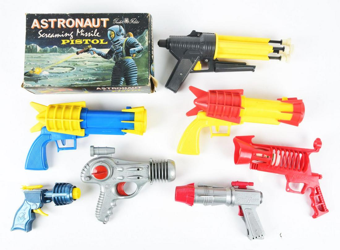 LOT OF 7: MADE IN ENGLAND SPACE GUNS.: Two are made in England "Screaming Missile Pistols," and one has the original box, but no darts are included. There is an Atomic Ray Pistol, Space Squadron Pistol, Clicker Gun with movable rocket and 