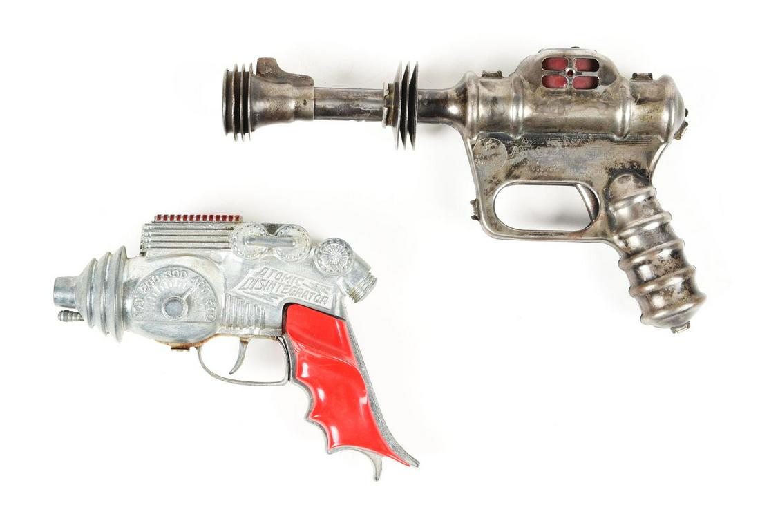 LOT OF 2: AMERICAN MADE VINTAGE SPACE PISTOLS.: One is tin litho Daisy Buck Rogers Atomic Pistol pop gun, where the trigger is stuck and not working. The second one is a Hubbly Atomic Disintegrator with the original plastic handles, and still click