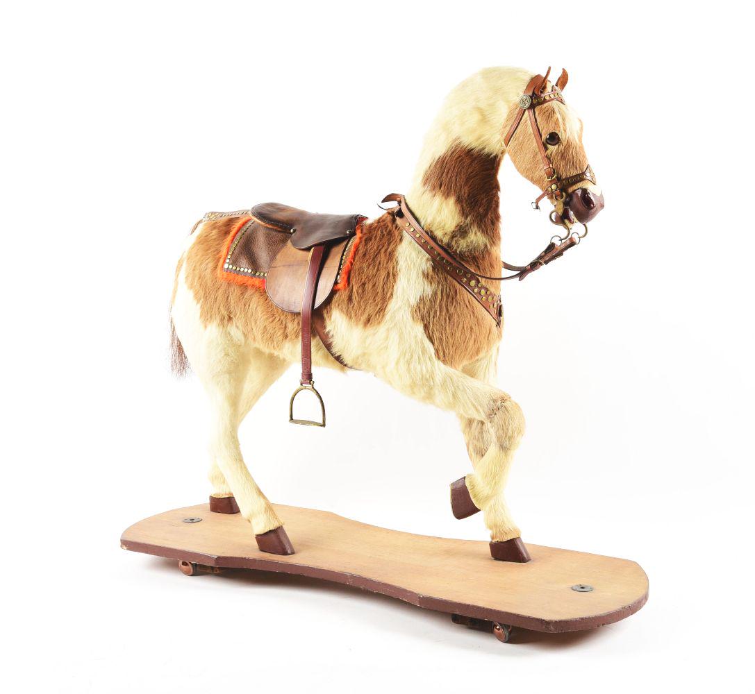 HORSE HIDE RIDING HORSE ON PLATFORM: Probably post-war with real horse hair. Condition:(Excellent).40" x 13 - 1/4" x 35 - 1/2".Dimensions: