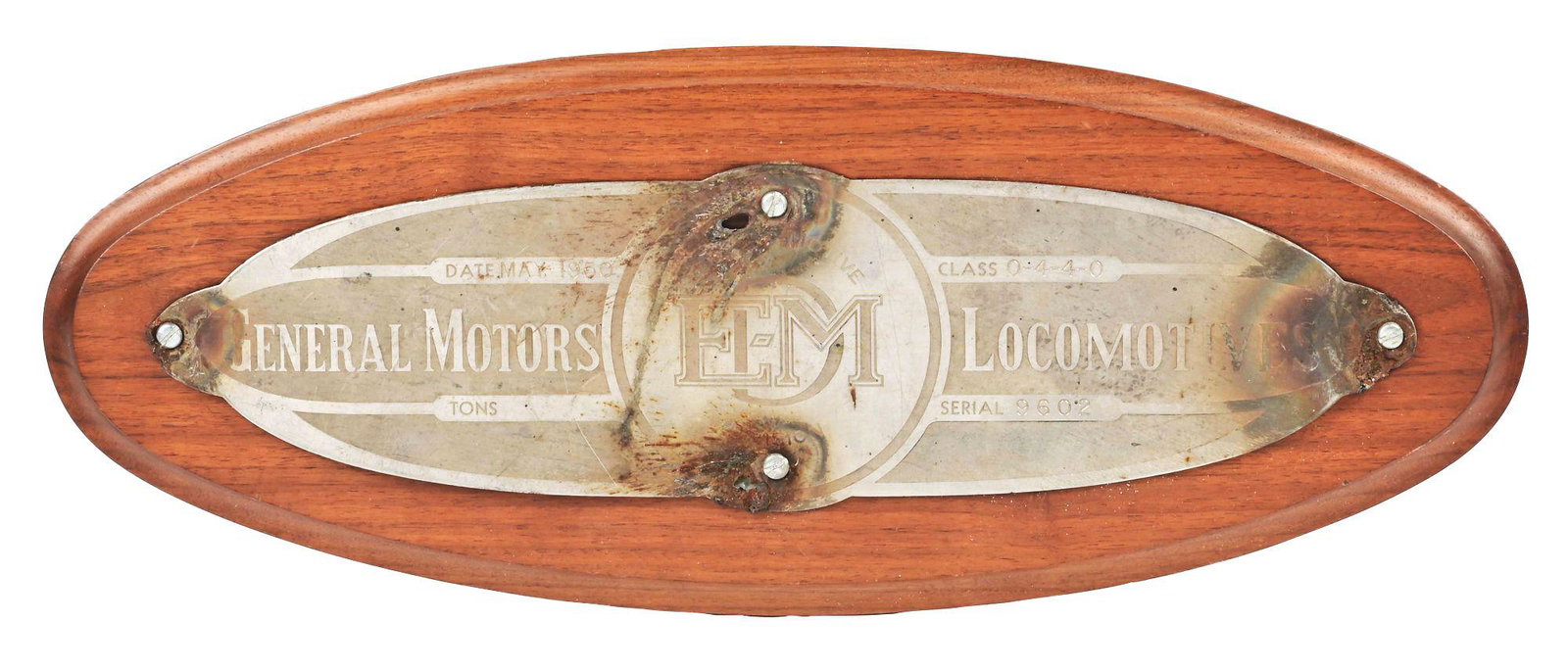 EMD LOCOMOTIVE BUILDER'S PLAQUE.: A hotdog-style plate, serial no. 9602, built date May, 1950, removed from Santa Fe F7A 239C, as indicated on the back of a mahogany mounting board. Mounting board is medium stain with routed edge. Pla