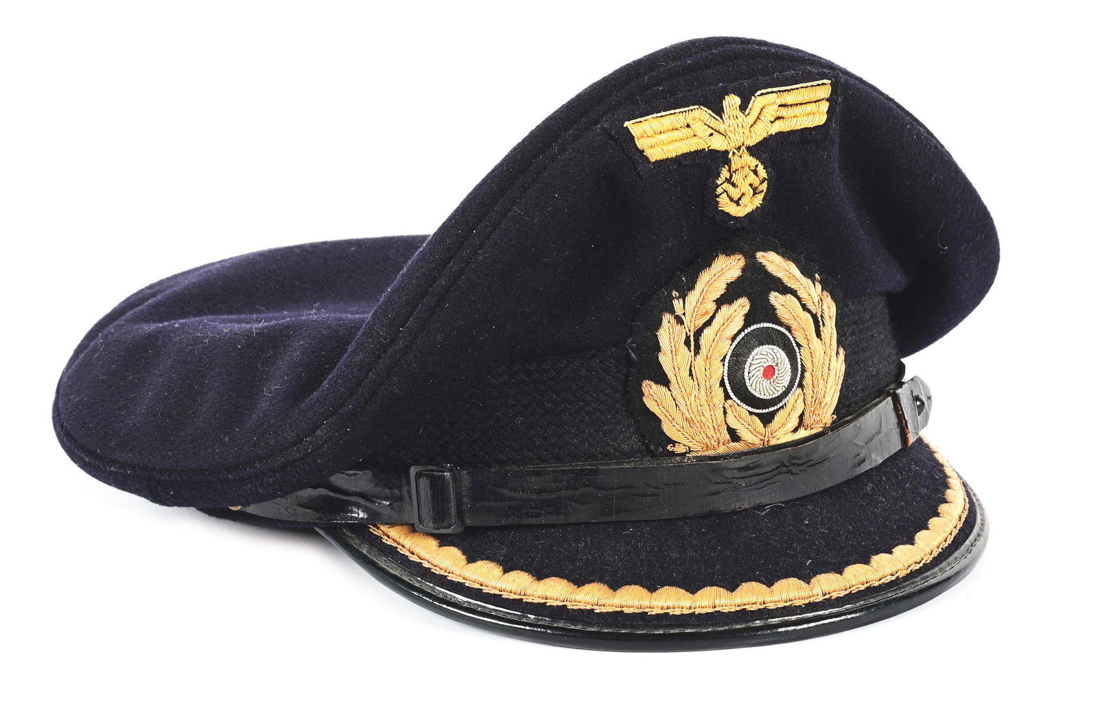 GERMAN WWII KRIEGSMARINE COMPANY GRADE OFFICER VISOR HAT.: German World War II Kriegsmarine company grade officer visor cap with an upper body made from a fine quality dark blue wool, exhibiting light staining and moderate amount of nap/ moth damage on top. T