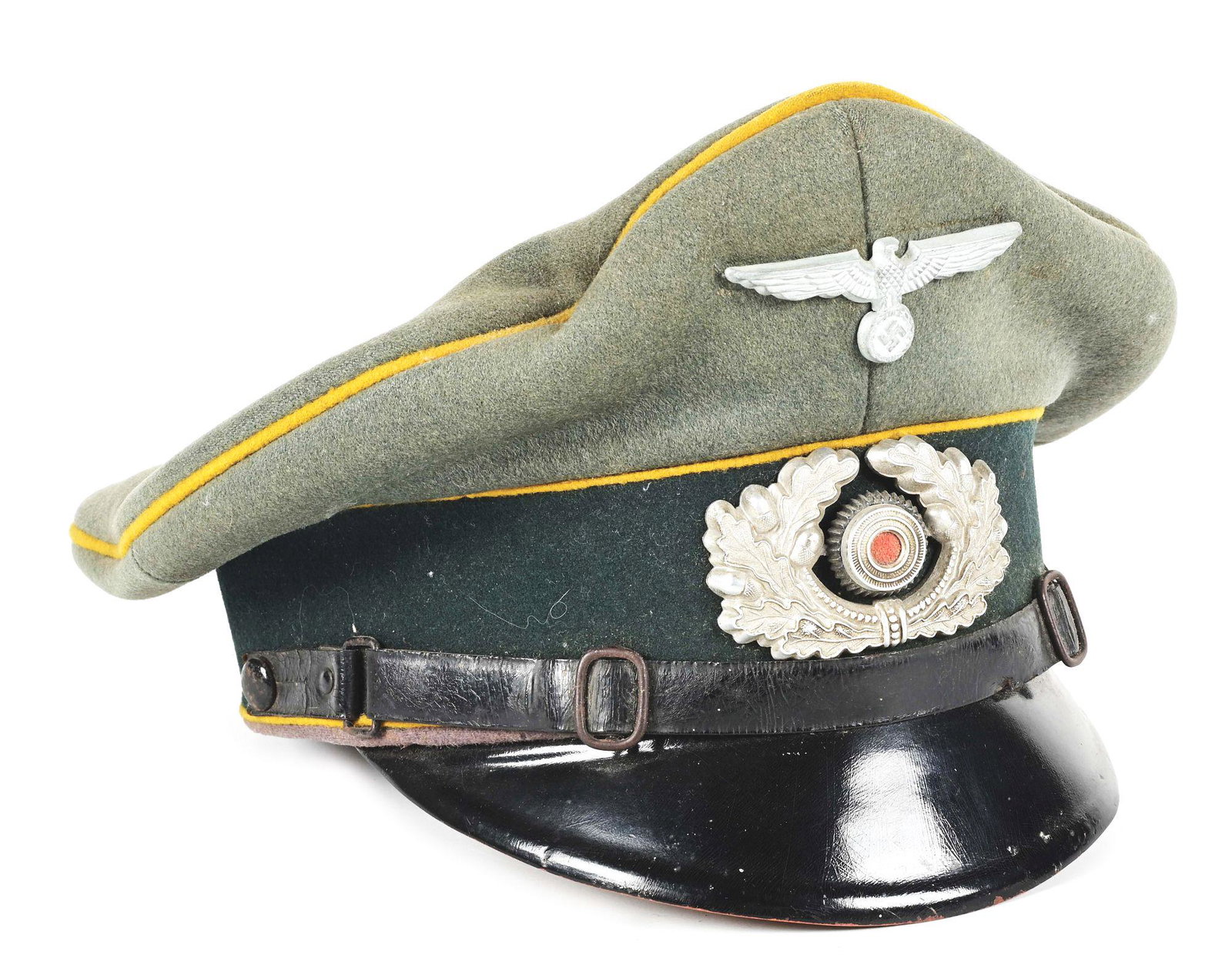 GERMAN WWII HEER CAVALRY ENLISTED VISOR HAT.: German World War II Heer cavalry enlisted visor cap made in a Feldgrau wool with light to moderate wear and damage, and moderate to heavy soiling. Light moth tracking and several nips, as well as a qu