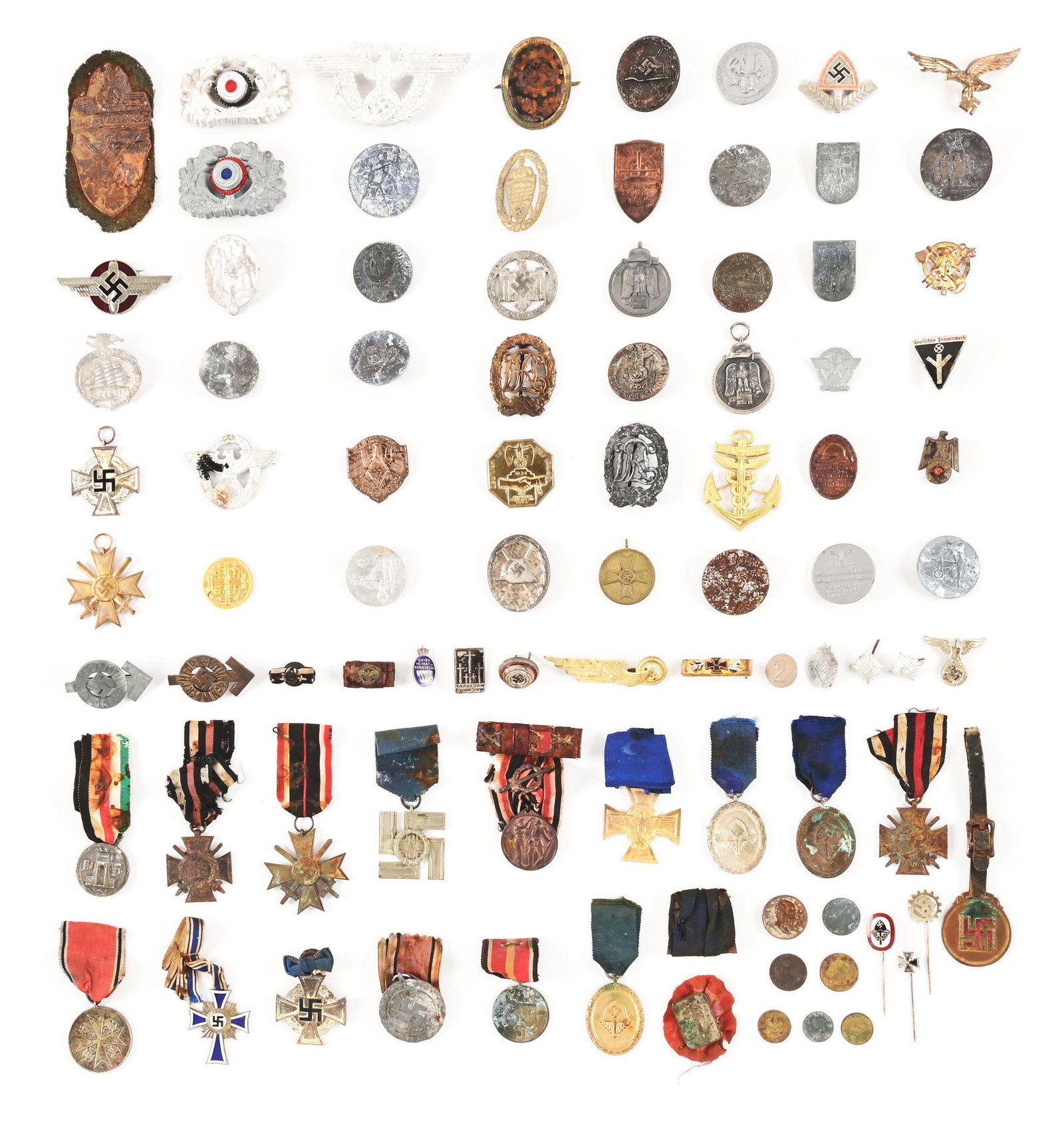 LARGE LOT OF MISCELLANEOUS THIRD REICH AWARDS AND TINNIES.: Lot contains of an assortment of Third Reich tinnies, cap eagles, pins, etc. of varying styles. There are also several badges and a Demyansk Shield. CONDITION: Varying condition, many appear to have g