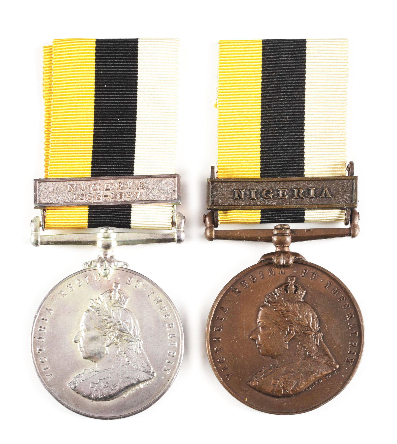 LOT OF 2: BRITISH 1899 ROYAL NIGER COMPANY'S MEDALS, 1 SILVER AND 1 BRONZE.: The Royal Niger Company’s Medal is a campaign medal issued in 1899 by the Royal Niger Company for service in minor military operations in Nigeria between 1886-1897. The lot consists of: (A) Silv