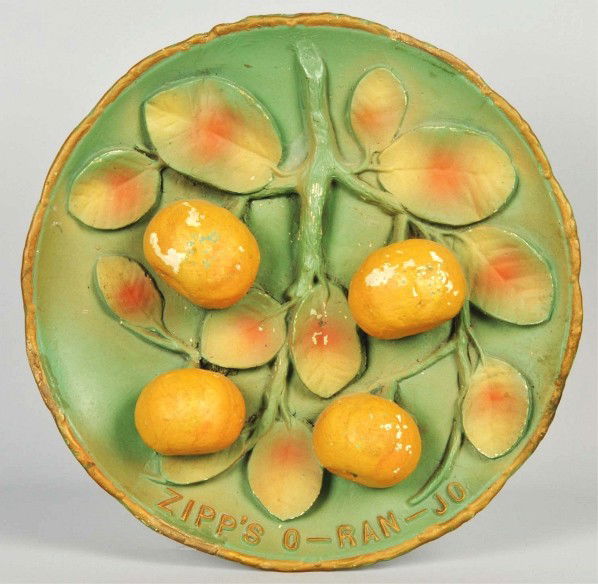 Embossed Plaster Zipp's O-Ran-Jo Wall Plaque.: Description Circa 1920s. Unusual and scarce item with minor color chips and nicks, light to medium soiling, and a few spots of old touchup. Condition (Very Good - Excellent). Size 13" Dia.